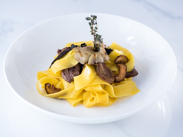 a plate of Pappardelle Mushrooms pasta at Uniworld
