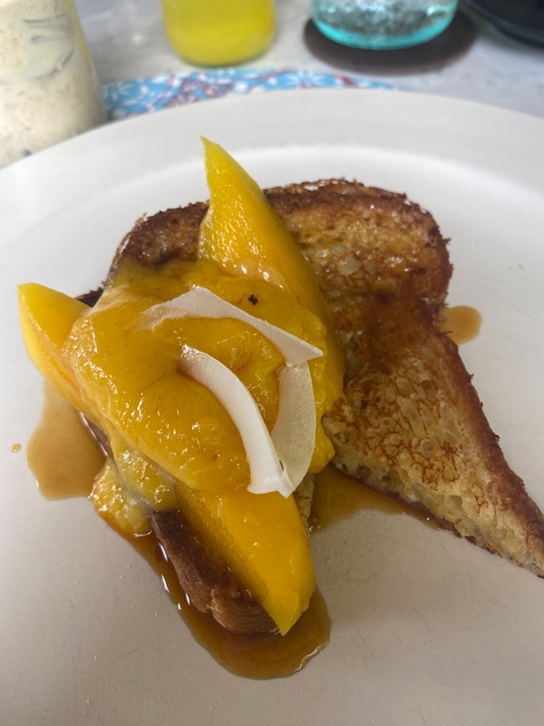 French toast with fresh mango, passionfruit curd and roast coconut