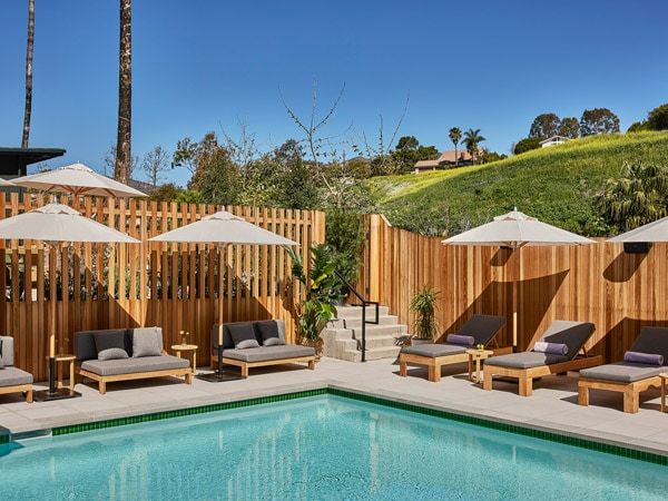 an outdoor pool with sun loungers at Hotel Juen