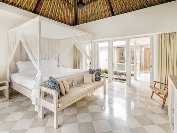 a cosy bedroom with rattan and lush cream furnishings at COMO Uma Ubud's Garden Pool Villa