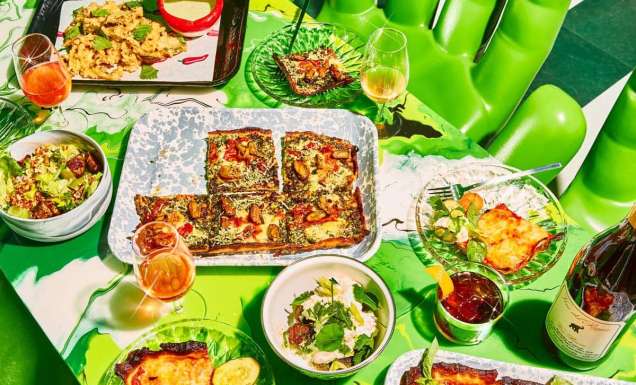 a wide selection of dishes on the green table at Shuggie’s Trash Pie and Natural Wine Bar
