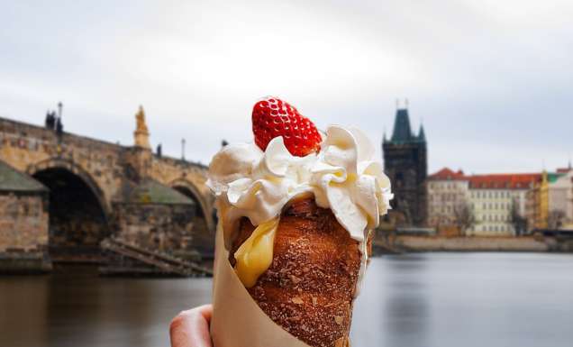 a hand holding Trdelník in Prague