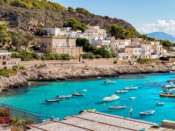 boats docked in the turquoise waters along Levanzo Island