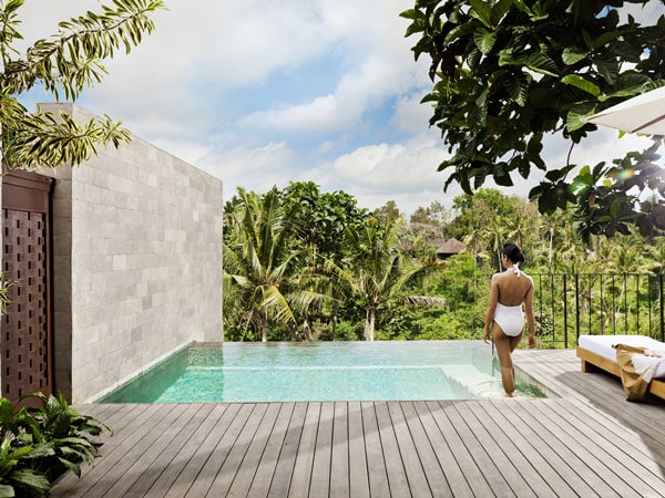 a woman standing on the edge of the outdoor pool at COMO Uma Ubud's Pool Villa