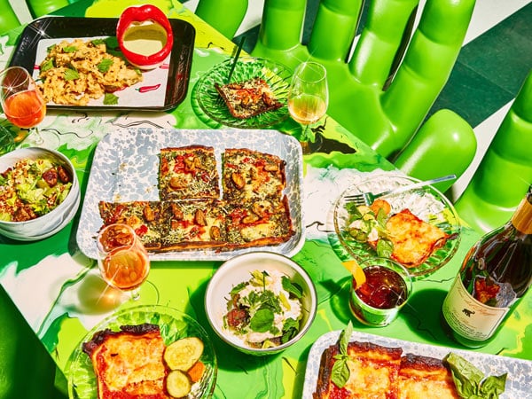 a wide selection of dishes on the green table at Shuggie’s Trash Pie and Natural Wine Bar