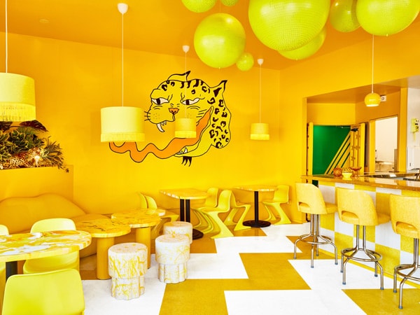 an eclectic yellow room at Shuggie’s Trash Pie and Natural Wine Bar