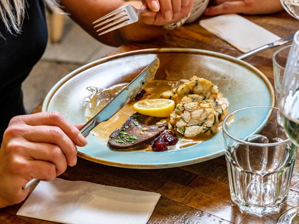 a person eating Svičková in a restaurant in Prague