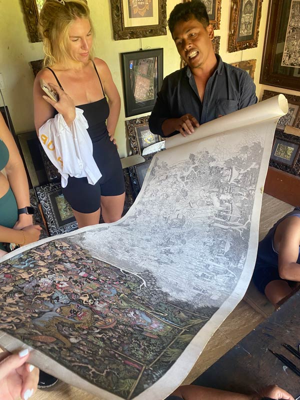 Wayan explaining the artwork process to guests at The Wayan Gama Painter Group and School