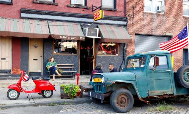 a woman sitting outside Sunny's Bar, Red Hook, NYC