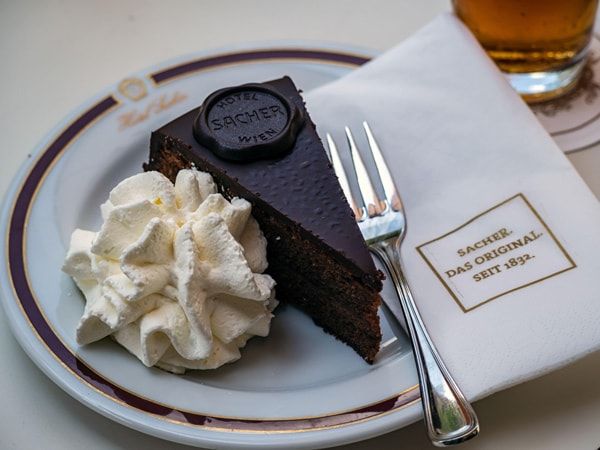 a slice of Sacher Torte cake on plate at the Cafe Sacher