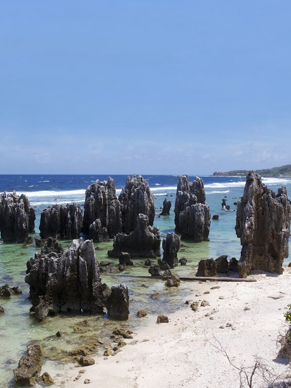 jagged rock formations along the beach in Nauru