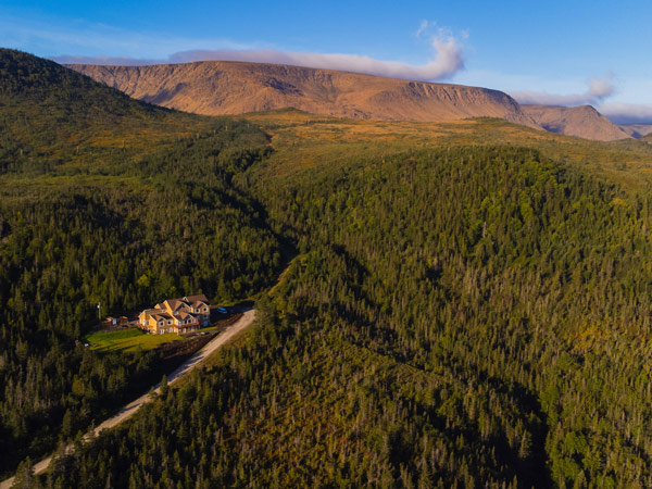 a drone view of Gros Morne Inn and The Tablelands