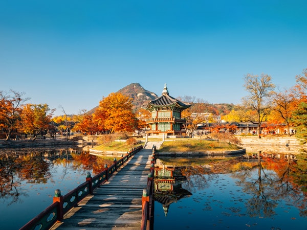 Gyeongbokgung Palace Hyangwonjeong with autumn maple in Seoul, Korea