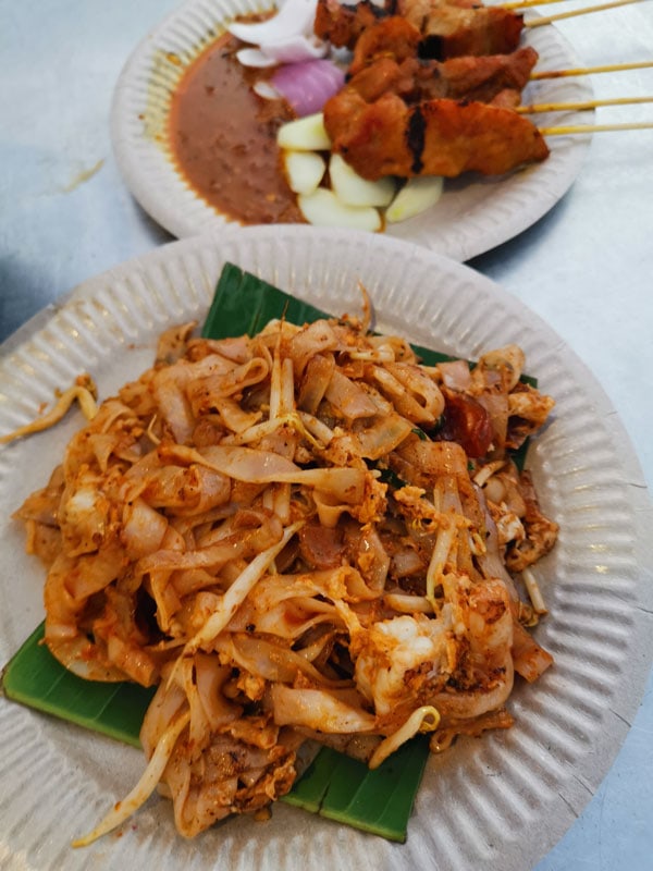 a Penang Char kuay teow and Malay satay, streetfood in Malaysia