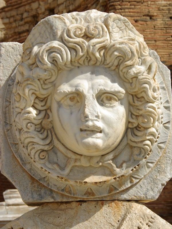 a stone medallion in the Roman ruins of Leptis Magna in Libya, Africa