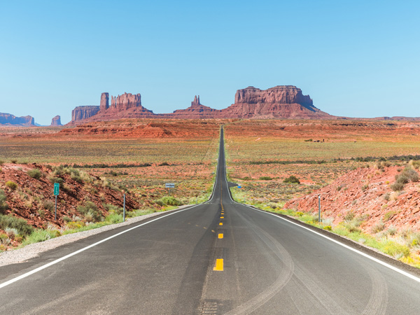views of Monument Valley National Park with famous buttes formations at background