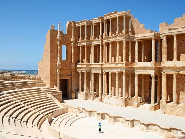a person standing on a Roman theatre ruins at Leptis Magna, Khoms, Libya