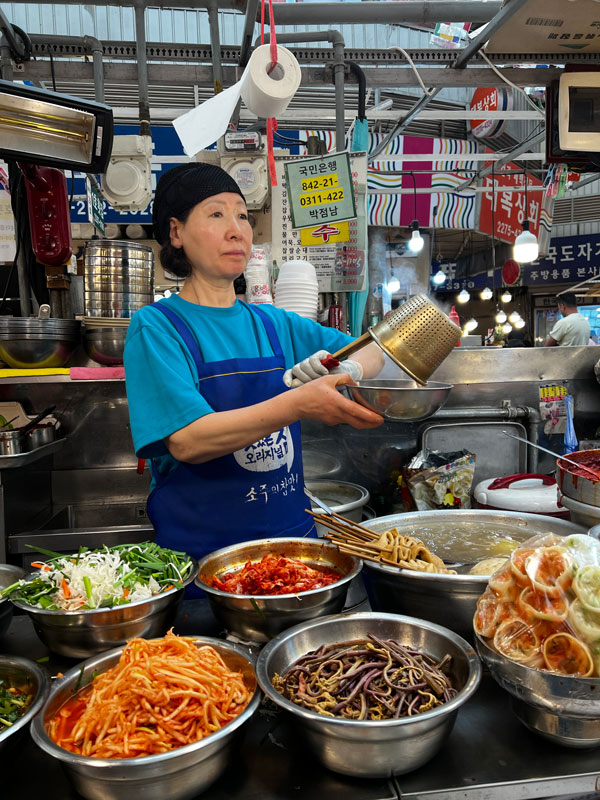 a vendor preparing mandu dumplings at Gwangjang Market