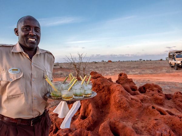 a server holding drinks at Satao Camp