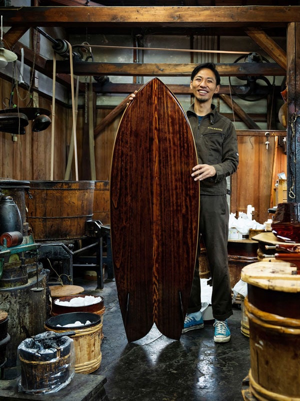 Tsutsumi Asakichi holding a surfboard, The Kyoto Artisan Concierge, Kyoto, Japan