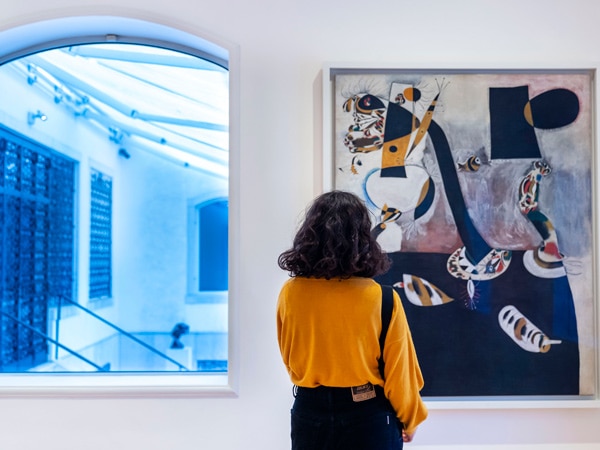 a woman staring at an art display in Peggy Guggenheim Collection, Venice, Italy