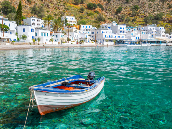 a boat moored in the seaside village of Loutro Crete