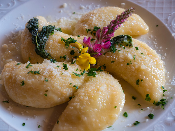 a plate of Schlutzkrapfen Truffled Ravioli