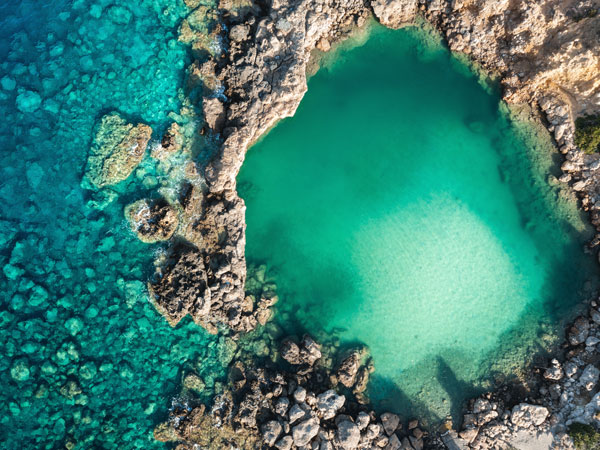 an aerial view of a small salt lake in Crete