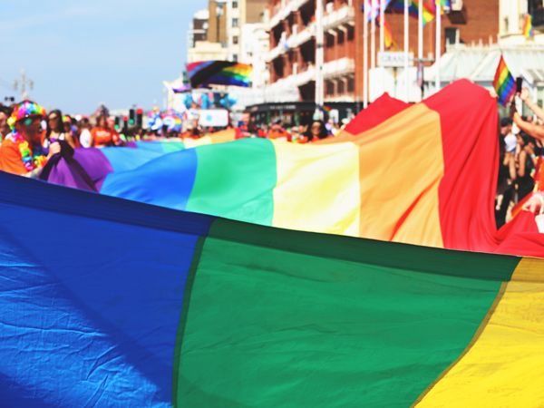 people laying down the pride flag during the event at Brighton