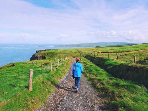 a person trekking the Cliffs of Moher walking trail