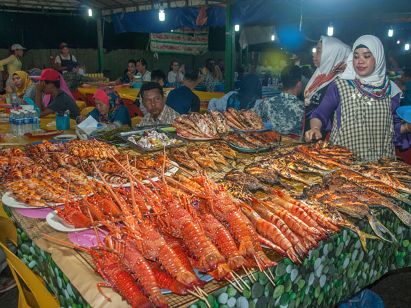 fresh seafood on display in a market stall at Kota Kina