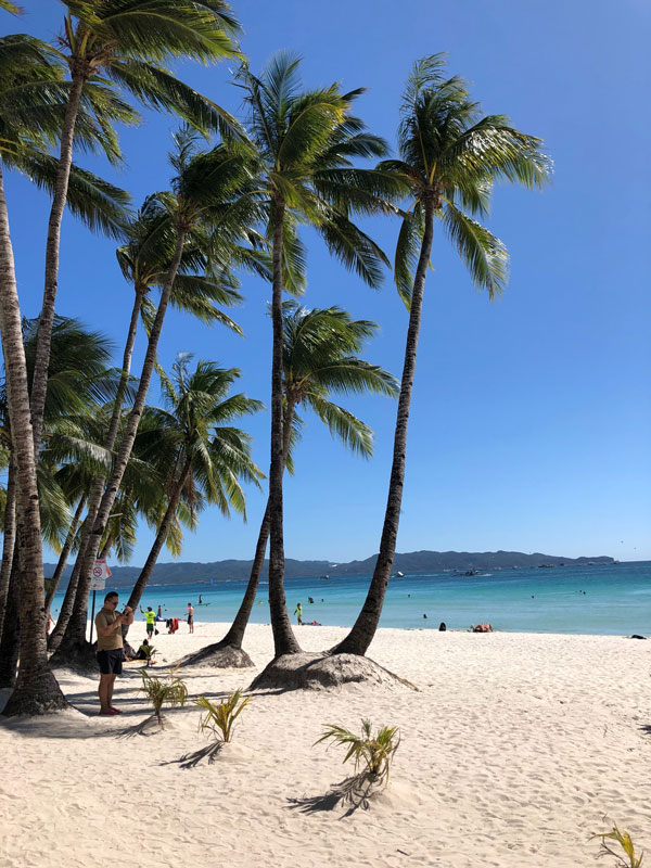 the white-sand beach of Boracay, Philippines on a sunny day