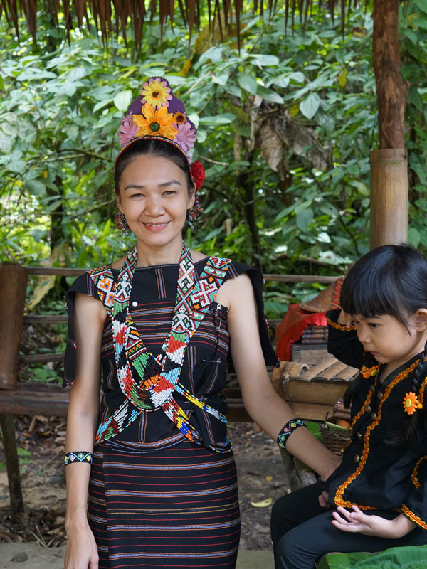a young woman dressed in traditional beads in Borneo