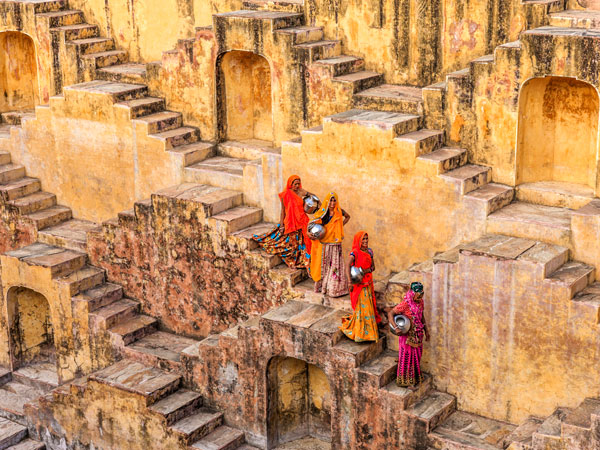 Indian women carrying water from the stepwells of Rajasthan near Jaipur