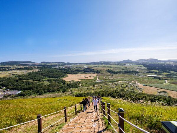 people hiking up the trail to the Saebyeol Oreum Volcanic Cone, Jeju Island, South Korea