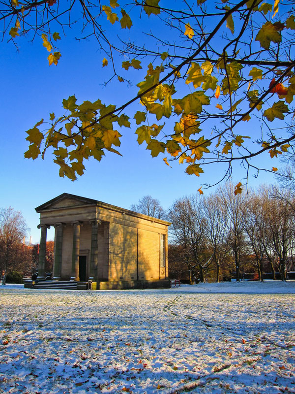 a historic structure in the snow-covered Leeds Park
