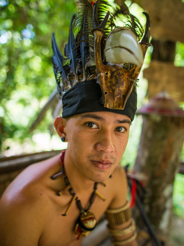 a man wearing a traditional headdress in Mari Mari Cultural Village 