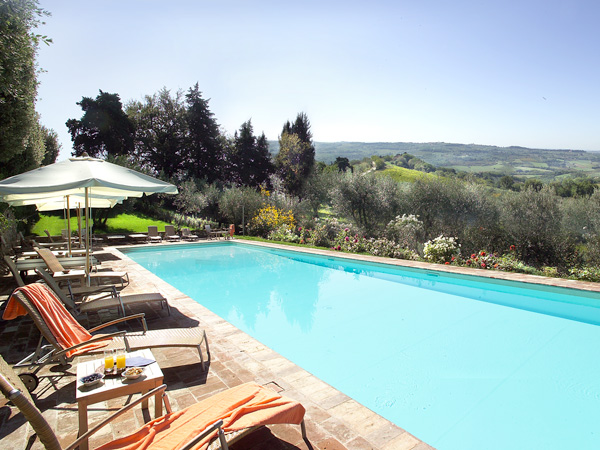 the pool with sun loungers at Villa il Poggiale