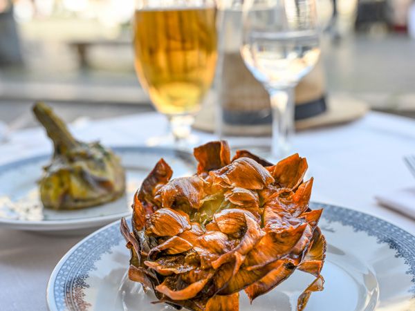 a fried artichoke on a plate at Piperno, Rome