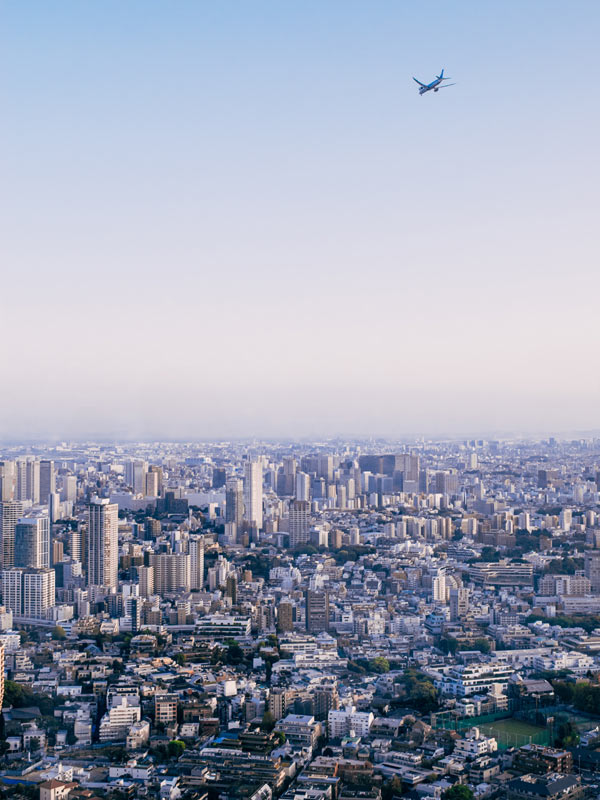 Plane soaring over Tokyo