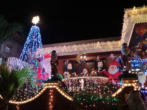 a house decorated with Christmas lights and Santa Claus statues along Policarpio St in Mandaluyong City, Metro Manila, Philippines