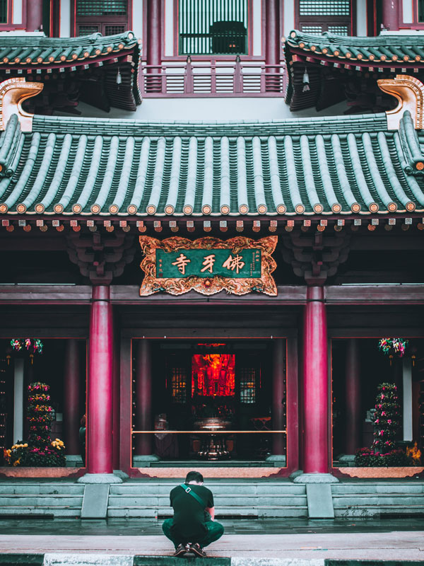 a devotee paying respects to the Buddha Tooth Relic Temple in Singapore