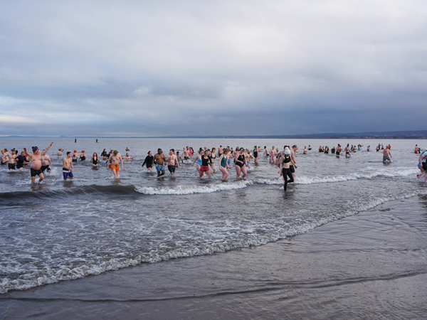 people dipping in Edinburgh River Forth, Loony Dook on New Year's Day