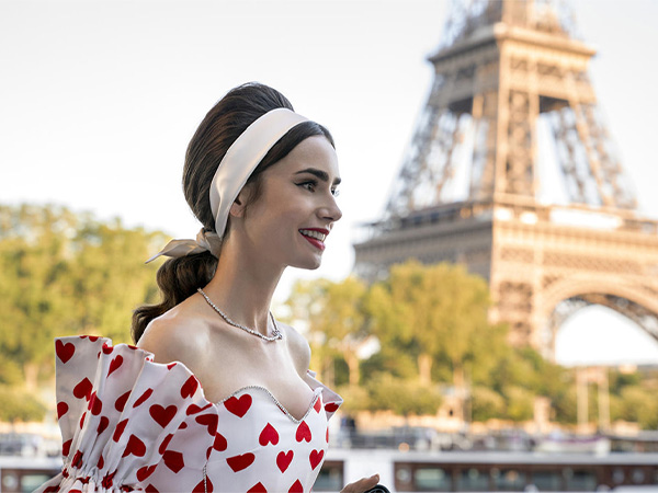 Lily Collins as Emily from Emily in Paris with Eiffel Tower behind