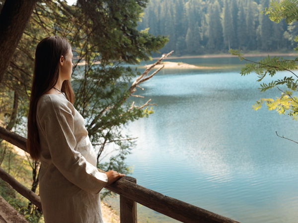 a pregnant woman admiring the beautiful scenery