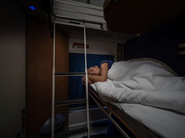 a female traveller in sleeper cabin of train at night