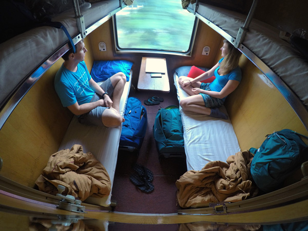 couple looking through the window while riding on sleeper train