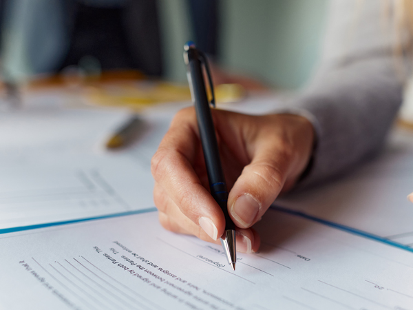 signing a travel insurance form