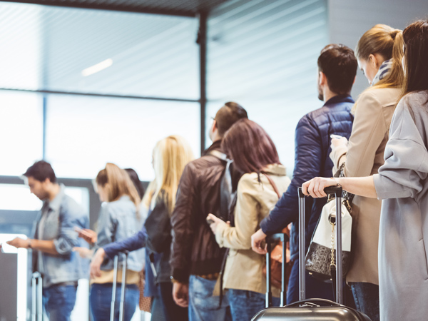 travellers lining up at the airport