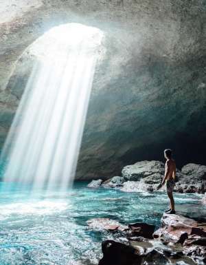 A man inside the Blue Cave on Tanna in Vanuatu